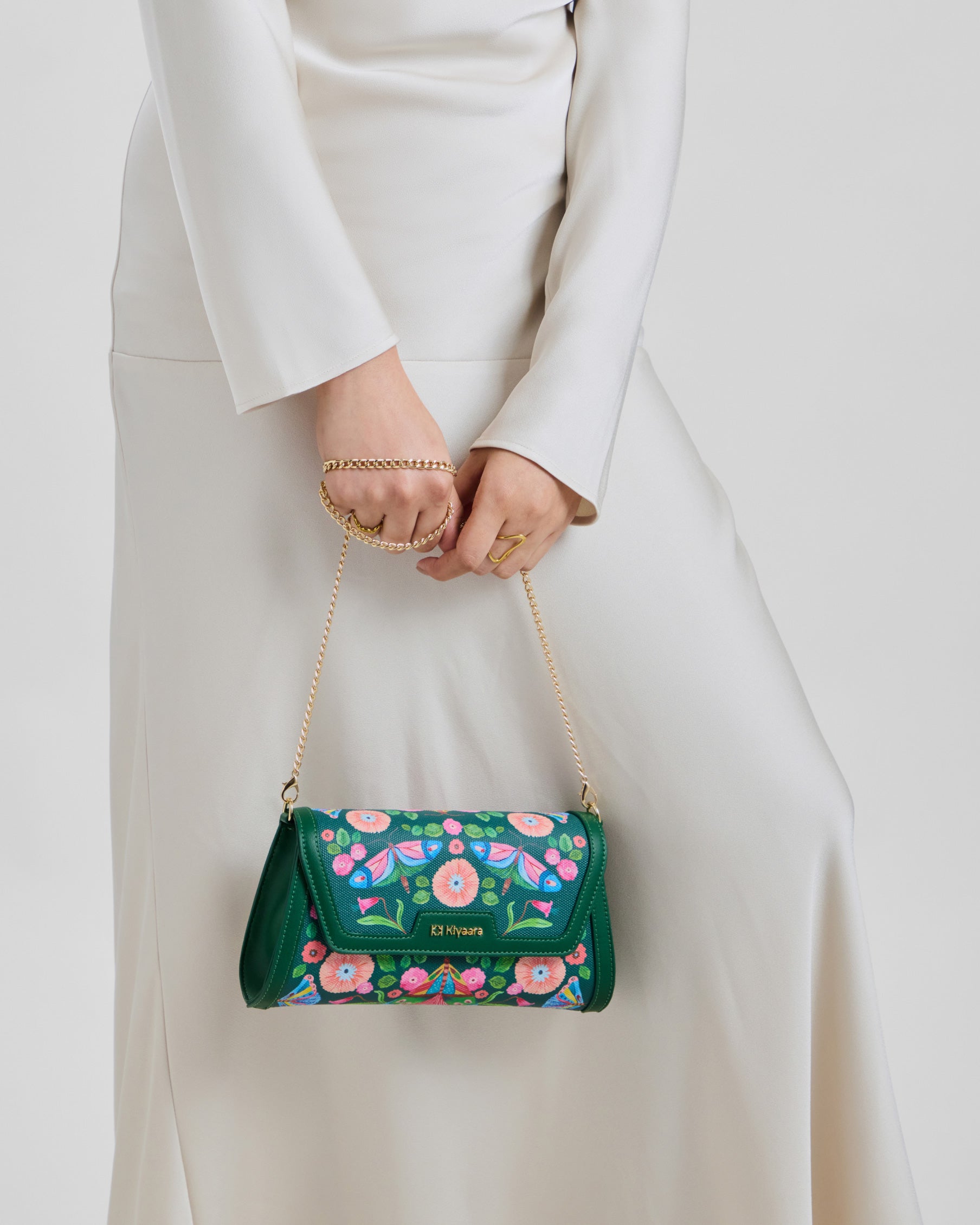 Flutter Clutch Bag in forest green vegan leather by House of Kiyaara, hand-painted butterfly artwork, shown as an evening transition clutch that transforms a daytime look